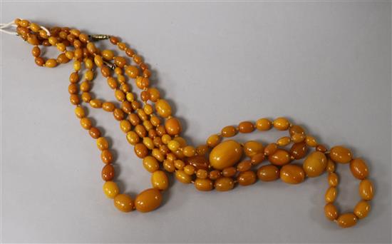 Three assorted single strand graduated amber bead necklaces.